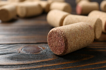 Many corks of wine bottles on wooden table, closeup