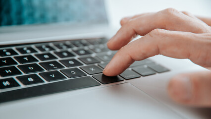 close up. man pressing the command key on his laptop.