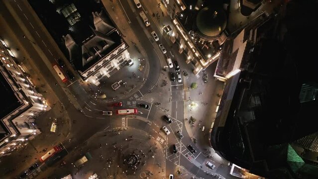 Establishing aerial top down of London UK Piccadilly Circus Regent Street and Leicester Square at Traffic Hour Cars And Double-Decker Bus Driving