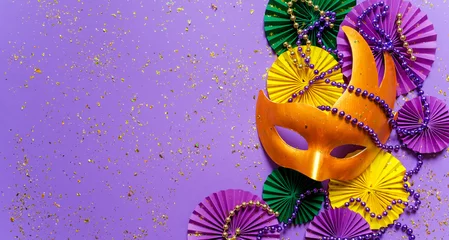 Selbstklebende Fototapeten Karneval Mardi gras.Holidays mardi gras masquarade, venetian mask  fan over purple background. view  above,mardi gras background copy space Happy Mardi Gras . Fat Tuesday carnival texture golden,green purple  © shintartanya