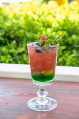 Mixed berry juice with mint on the wooden table