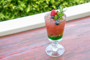 Mixed berry juice with mint on the wooden table