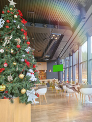 Pub Interior With Christmas Tree, Ornaments, Bar Counter And Tables