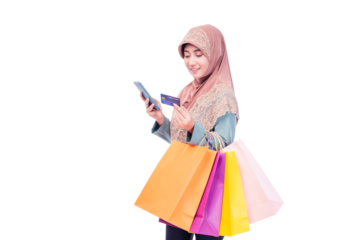 Young Muslim lady using mobile phone holding credit card carry shopping bags isolated over pastel light blue background copy space Smiling young girl purchasing online through phone using credit card