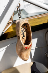 A wooden shoe serving as a tip collection bin in Delft, Netherlands