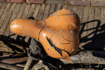 A weathered and torn bike seat of an abandoned bicycle in Delft, Netherlands