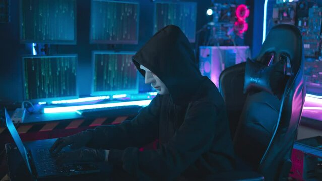 Close-up face hacker With a mask executing digital espionage