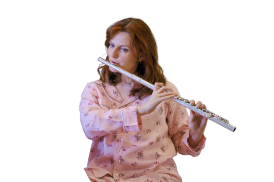 Recording an online flute lesson from your home kitchen, isolated on a white background. Woman plays a musical wind instrument while looking at her phone in quarantine