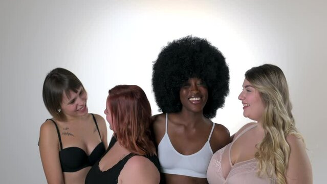 Body Positive and Acceptance, multiracial group of women with different body and ethnicity looking at the camera and smiling, curvy, plus size and skinny kind of female body concept, slow motion