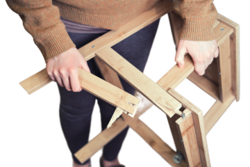 Leg of the wooden chair broke at the base, isolated on a white background. Stepladder broken in the woman hands, isolated on a white background. Problems with safety at work at home