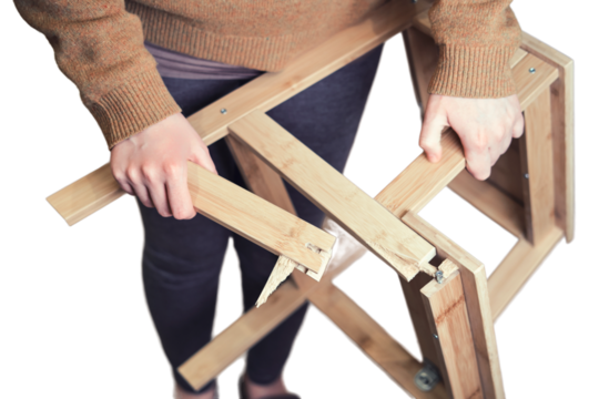 Leg of the wooden chair broke at the base, isolated on a white background. Stepladder broken in the woman hands, isolated on a white background. Problems with safety at work at home