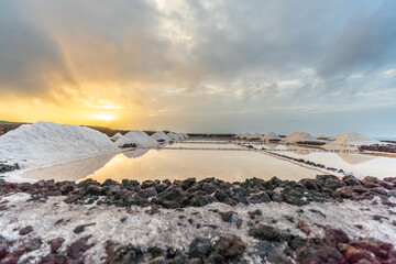 Piles of salt over the salt mine ponds at dawn