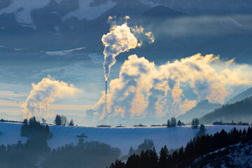 environmental burden in winter landscape, smoked chimneys - 557924392