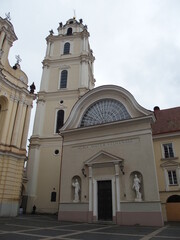On the right a building of the Alma Mater Vilnensis, Vilnius, Lithuania, in the background the steeple of St. John's Church
