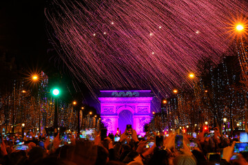 Paris, France - January 1st, 2023 : New Year's fireworks over the Arc de Triomphe (triumphal arch)...