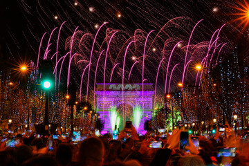 Paris, France - January 1st, 2023 : New Year's fireworks over the Arc de Triomphe (triumphal arch)...