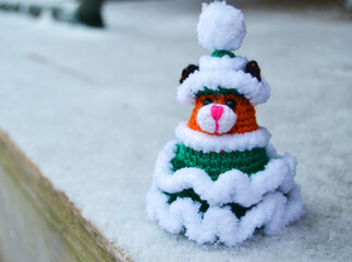 Toy Knitted Christmas Tree Green on the Snowy Threshold of the House