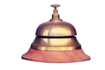 Vintage table bell made of yellow metal, isolated on a white background