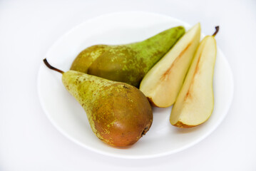 Chopped green pears on a plate. Delicious pear. A served plate with a pear.
