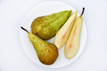 Chopped green pears on a plate. Delicious pear. A served plate with a pear.