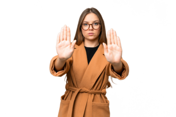 Young blonde woman over isolated chroma key background making stop gesture and disappointed