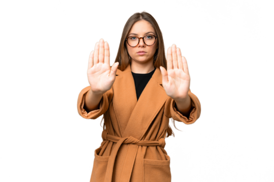 Young blonde woman over isolated chroma key background making stop gesture and disappointed