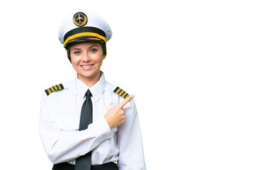 Airplane pilot woman over isolated chroma key background pointing to the side to present a product
