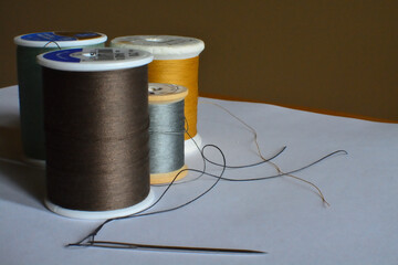 four spools of thread with needle