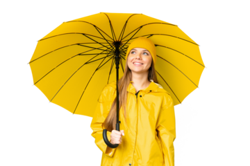 Young blonde woman with rainproof coat and umbrella over isolated chroma key background thinking an idea while looking up