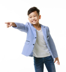 Asian boy in casual suit posing portrait, smiling fully and pointing his hand to a blank space in the picture. - 557931155