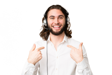 Telemarketer man working with a headset over isolated chroma key background with surprise facial expression