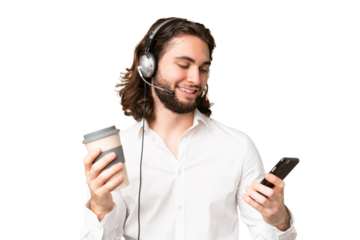 Telemarketer man working with a headset over isolated chroma key background holding coffee to take away and a mobile