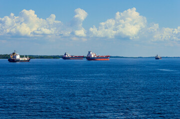 Cargo ships travelling along the Amazonas river in Brazil along the route between manaus and Belem