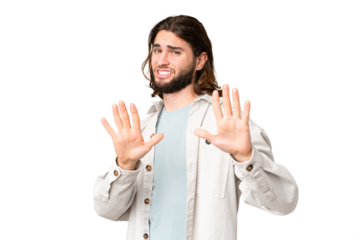 Young handsome man over isolated chroma key background nervous stretching hands to the front