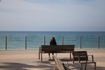 person sitting on a pier