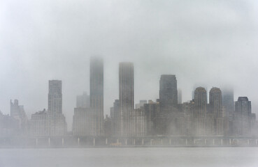 Hudson river in Winter with Misty New York Cityscape in Background. NYC, USA