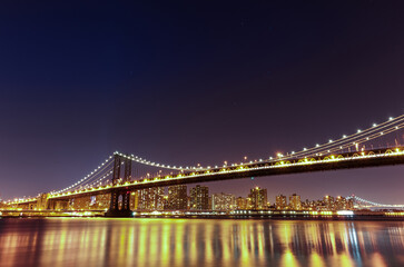 Manhattan Bridge at Night. Long Exposure. New York. NYC, USA. Lights Reflection on Water.