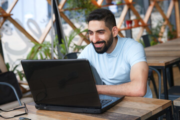 Portrait of Arab Arabian young handsome happy muslim bearded man with beard in casual clothes,...