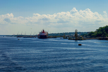 Industrial site on the river banks of Rio Amazonas in Brazil surrounded by the green rainforest