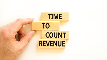 Time to count revenue symbol. Concept word Time to count revenue on wooden blocks. Businessman hand. Beautiful white table white background. Business and time to count revenue concept. Copy space.
