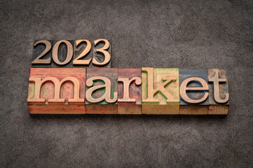 Fototapeta premium 2023 market prediction banner in vintage letterpress wood type against grunge handmade paper, finance, economy and recession concept