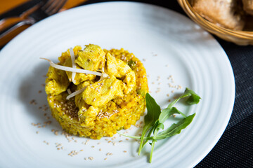 Curry risotto with chicken Risotto is a northern Italian rice dish cooked with broth until it reaches a creamy consistency.