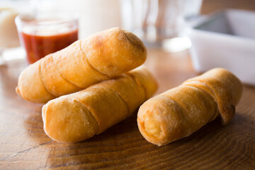 Tequeño is a fried breaded cheese stick or bread dough spear with white cheese stuffed in the middle, and is a popular meal or snack in Chile.