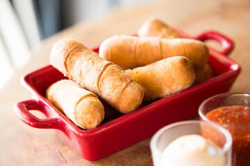 Tequeño is a fried breaded cheese stick or bread dough spear with white cheese stuffed in the...