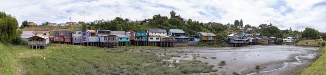 Fototapeta na wymiar Panorama of the Palafitos de Pedro Montt - colorful stilt houses on Chiloé (Isla Grande de Chiloé) in Chile 