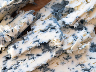 Tasty moldy cheese texture background. Blue mold cheese close up