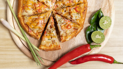 Tom Yum Pizza made by Thailand, Ingredients of Tom Yum Kung are the original curry paste, Lemongrass, Kaffir lime leaves and lime. Promotional poster for restaurant or pizza sale, Text space.
