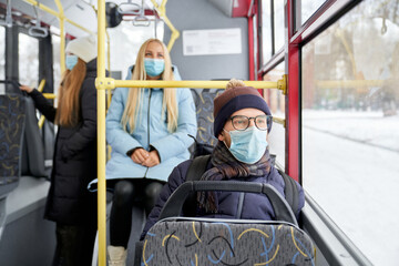 Fototapeta na wymiar Portrait of passengers protecting themselves against coronavirus getting work home school. Ordinary day in public transport while covid spreading. Concept of nowadays reality while quarantine.