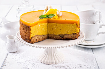 Traditional German cheesecake with mango served as close-up on a cake plate