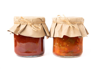 Canned tomato sauce, prepared at home and eggplant salad in glass jars isolated on white background. Pickled jars.